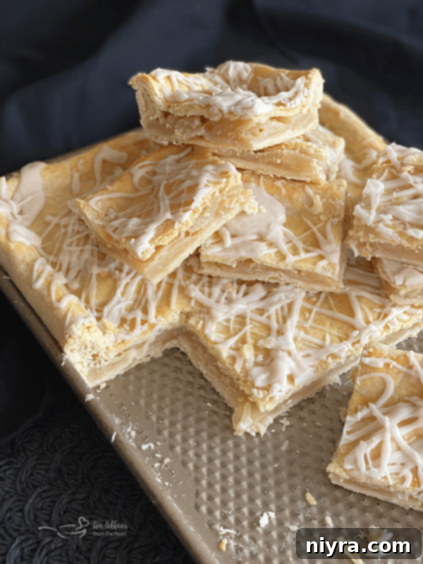Freshly baked Apple Bars on a cookie sheet, cooling down, with a golden brown crust