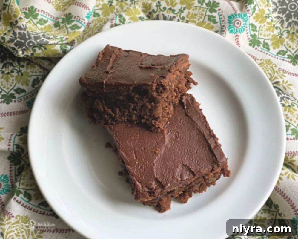 Decadent Chocolate Banana Bars 4 Overhead shot of a tray of freshly baked Chocolate Banana Bars, pre-frosting, with a few walnuts visible.