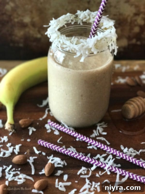 Decadent Chocolate Banana Bars 9 A refreshing Nutty Monkey Smoothie in a glass, with bananas and nuts in the background.
