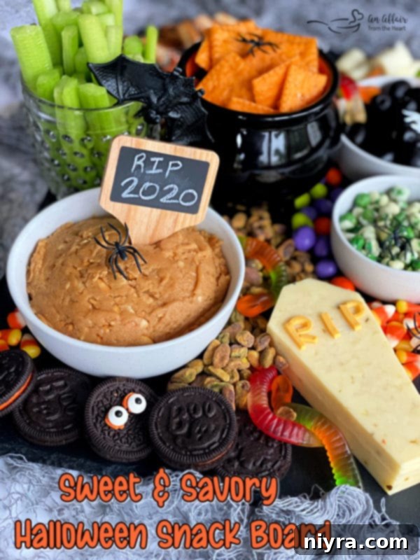 Spooky Sweet and Savory Halloween Snack Board with Peanut Butter Dip 12 The hero shot of the Halloween snack board, showcasing its full glory with all components.