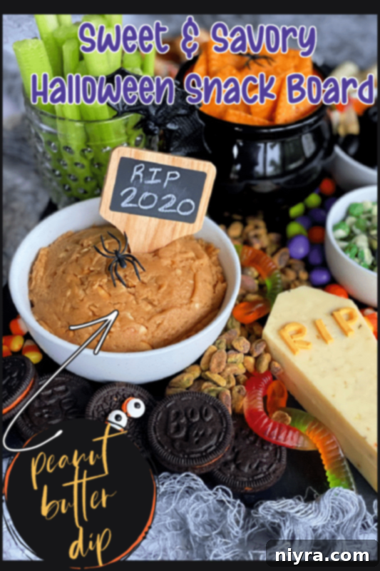 Spooky Sweet and Savory Halloween Snack Board with Peanut Butter Dip 9 A beautifully arranged Halloween snack board with a focus on the sweet and savory elements.