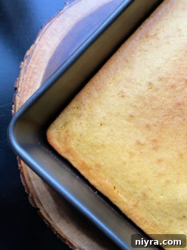 Honey cornbread batter spread in a baking dish