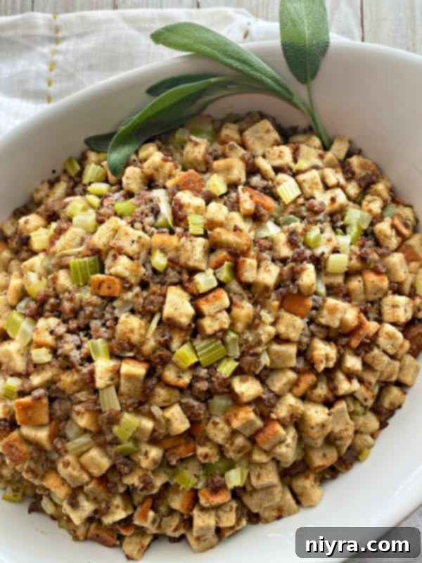Mom's Sausage & Sage Dressing in a bowl with serving spoon