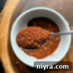Homemade Chili Seasoning in white bowl with spoonful