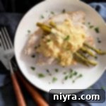 Overhead view of Turkey Oscar with creamy Hollandaise, succulent shrimp, and tender crabmeat, exquisitely presented for a gourmet meal.