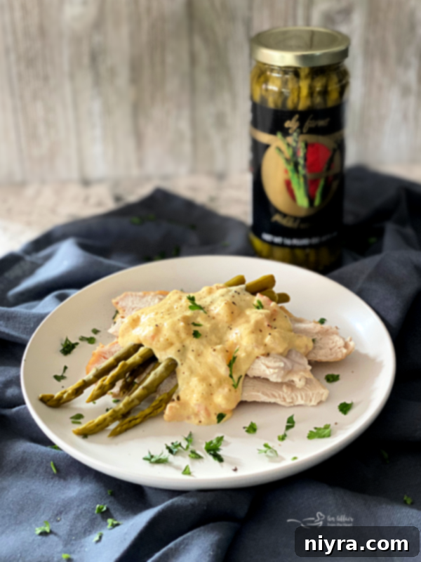 Close-up of a jar of Ely Farms Pickled Asparagus, showcasing the vibrant green spears and clear pickling liquid, highlighting the quality and artisanal presentation of the product.