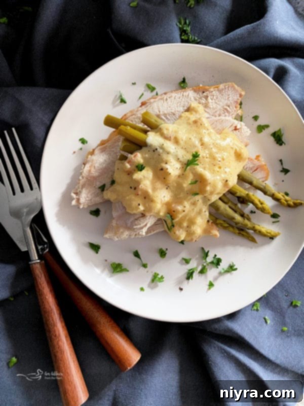 A vibrant and appetizing full-plate view of Turkey Oscar, showcasing its elegant presentation with a golden Hollandaise sauce cascading over turkey, asparagus, shrimp, and crab, ready to be savored by delighted diners.