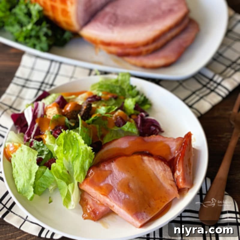 Sweet and Sticky Slow Cooker Ham 11 Dorothy's Holiday Glazed Ham presented beautifully on a platter with garnishes, ready to be enjoyed as a festive meal.