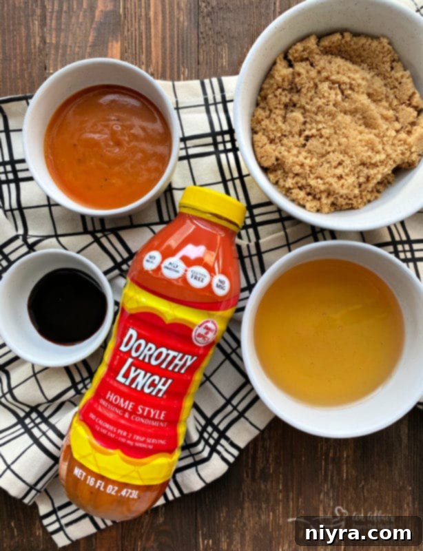 Sweet and Sticky Slow Cooker Ham 5 Ingredients for Dorothy Lynch ham glaze laid out, including a bottle of Dorothy Lynch dressing, honey, brown sugar, and molasses.