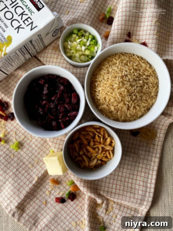 Ingredients for Rice Pilaf with Dried Cranberries and Slivered Almonds laid out.