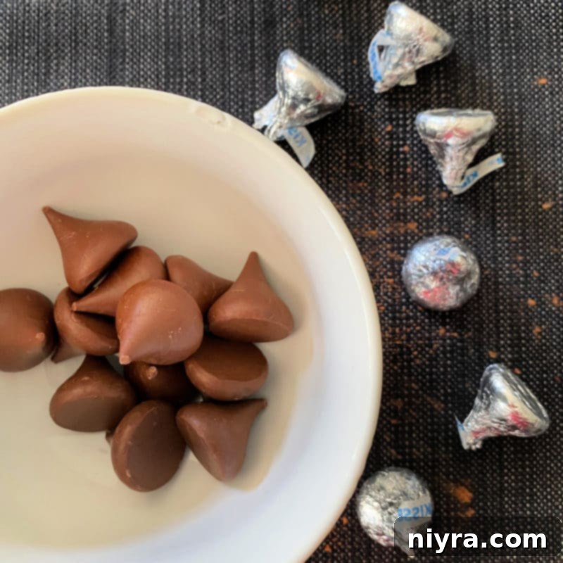 Step-by-step photo showing chocolate sugar cookie dough being mixed with cocoa powder in a bowl, a key step for Halloween chocolate sugar cookies.