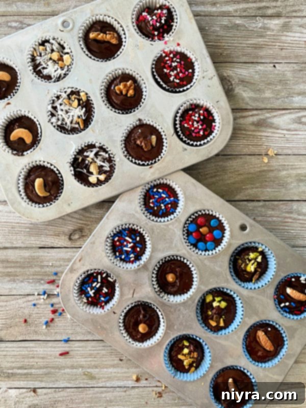 Pouring melted chocolate into muffin liners with fillings