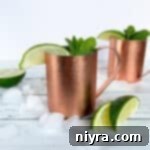 Copper Kick Refresher 13 Side view of 2 Moscow Mule cocktail in a copper mug.