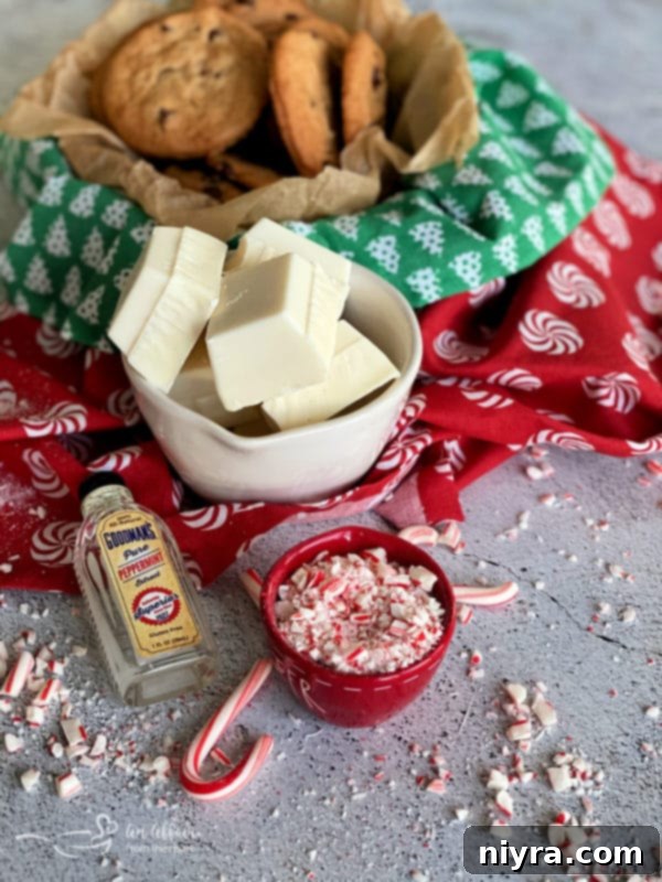 A bowl of white almond bark with crushed candy canes beside it.