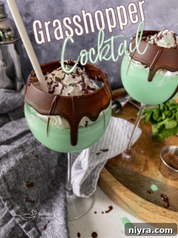 Emerald Dream 16 A delicious Grasshopper Cocktail in a tall glass, garnished with a chocolate wafer.