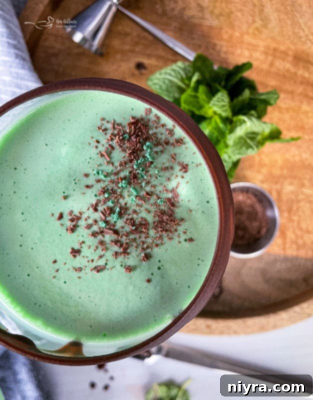 Emerald Dream 8 A freshly blended Grasshopper Cocktail being poured into a tall glass.