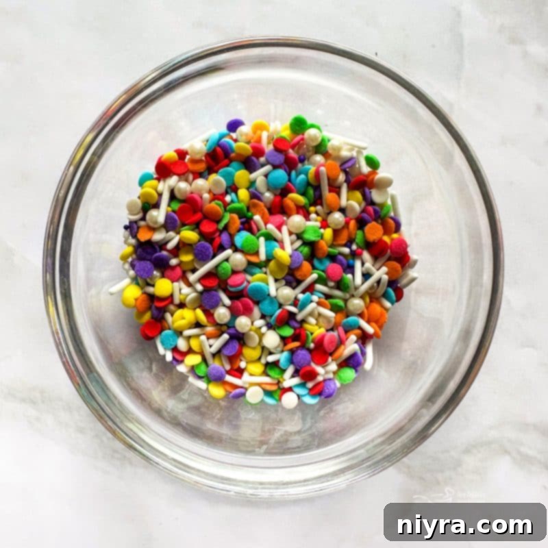 Mixing frosting ingredients in a stand mixer.