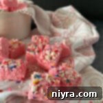 Pink Valentine fudge up close, showing its creamy texture and sprinkles