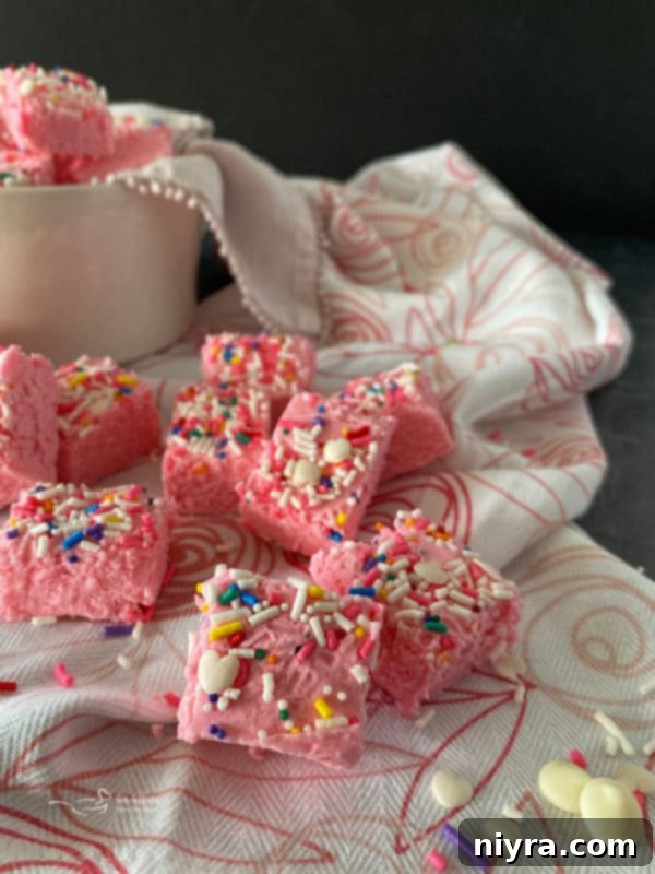 Delicious Valentine fudge squares with heart sprinkles on a white plate