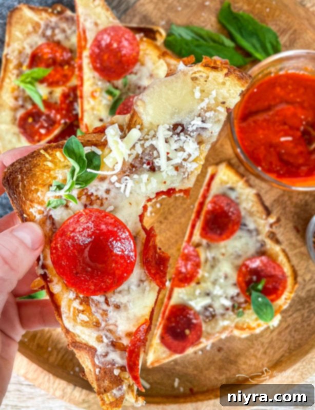 Close-up of the pepperoni pizza grilled cheese interior, showing melted cheese and layers