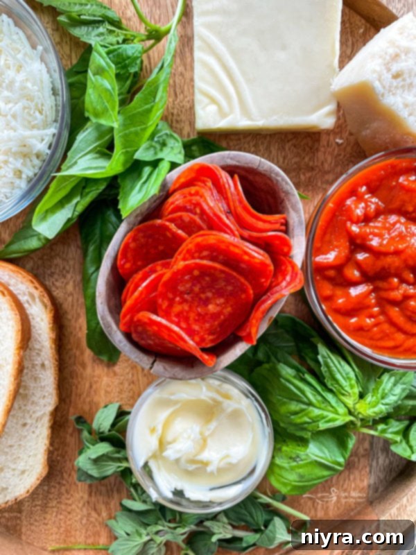 Ingredients for pepperoni pizza grilled cheese laid out on a cutting board
