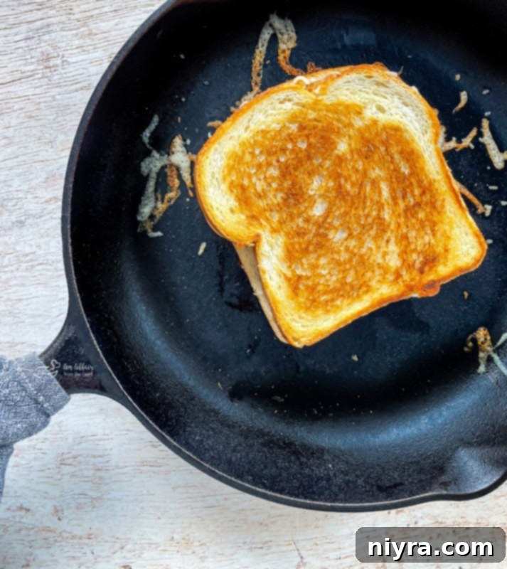 Pepperoni pizza grilled cheese cooking in a cast iron skillet