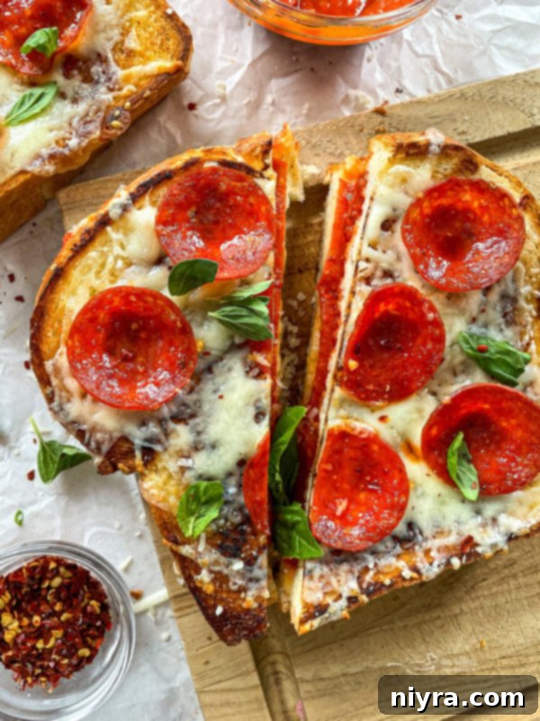 Cooked pepperoni pizza grilled cheese, topped with extra cheese and pepperoni, ready for broiling