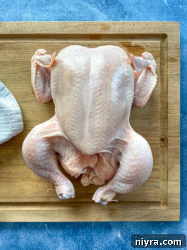 Top view of whole chicken on cutting board