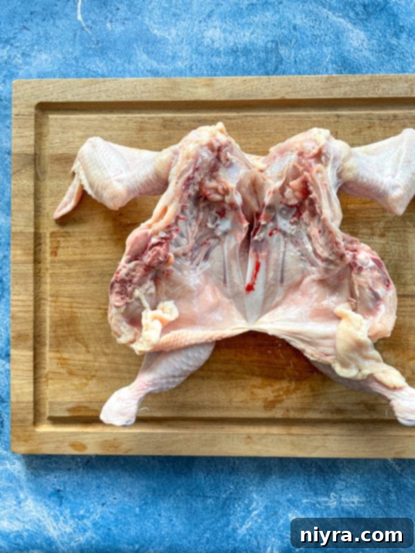 Spatchcocked chicken on cutting board