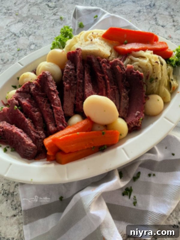 Platter of sliced corned beef, cabbage, carrots, and potatoes