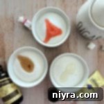 Small bowl of sugar with extract being added.