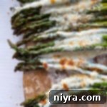 Top view of asparagus topped with melted cheeses