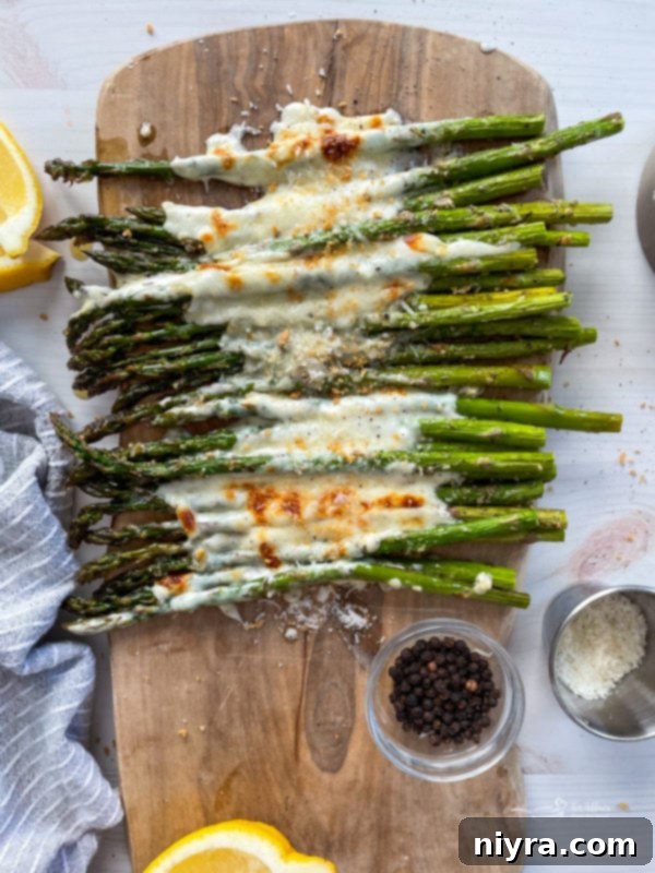 Top view of garlic cheese asparagus with melted cheese