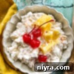 Top view of piña colada fluff salad with cherries