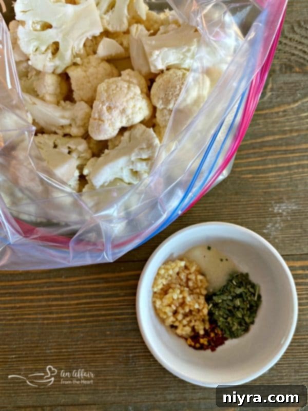 Crispy Roasted Cauliflower 4 Fresh cauliflower florets in a large Ziploc bag with a small bowl of mixed spices next to it.