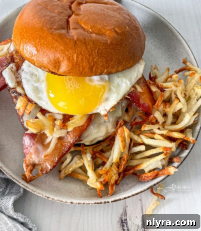 A stacked Hangover Burger showcasing all its delicious toppings