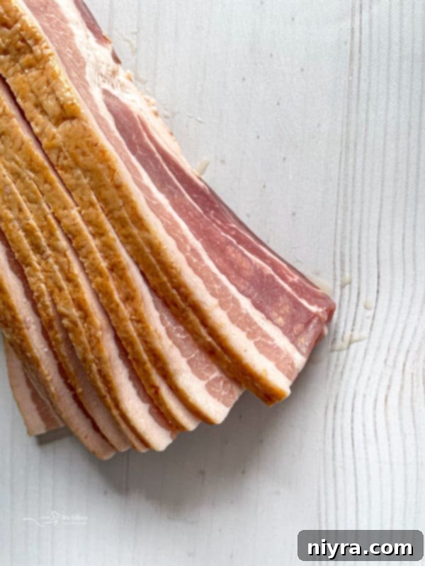 Assortment of Hangover Burger toppings: pepper jack cheese, crispy hash browns, cooked bacon, and fried eggs