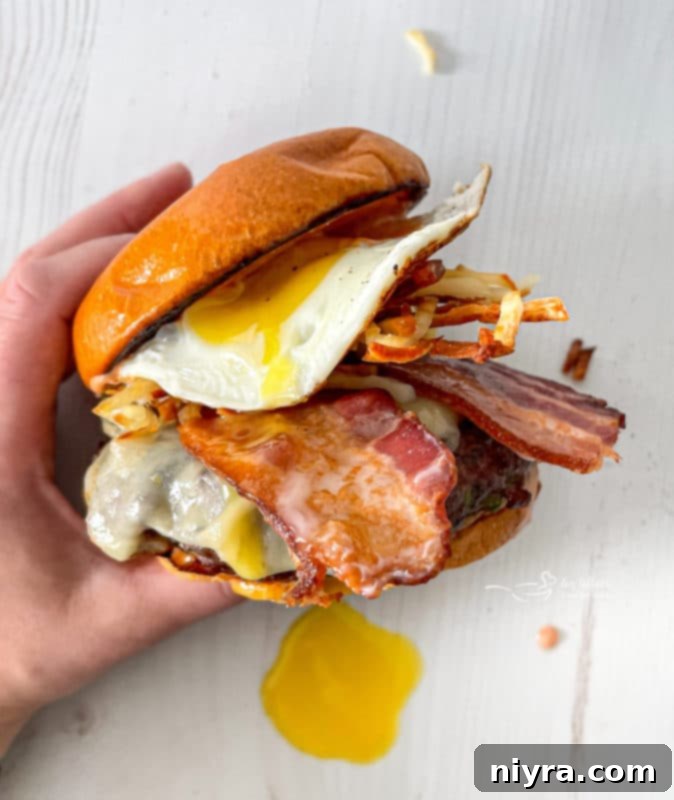 Close-up view of a fried egg with a runny yolk, a key topping for the Hangover Burger