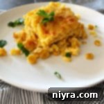 Golden Corn Bake 15 Corn pie on white plate with parsley