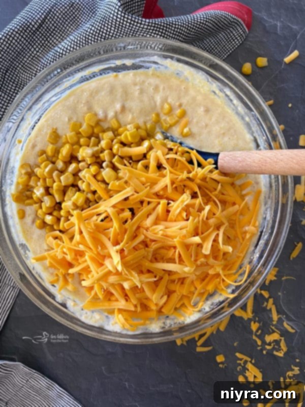 Golden Corn Bake 9 Corn pie mixture with shredded cheddar cheese folded in, ready for baking.