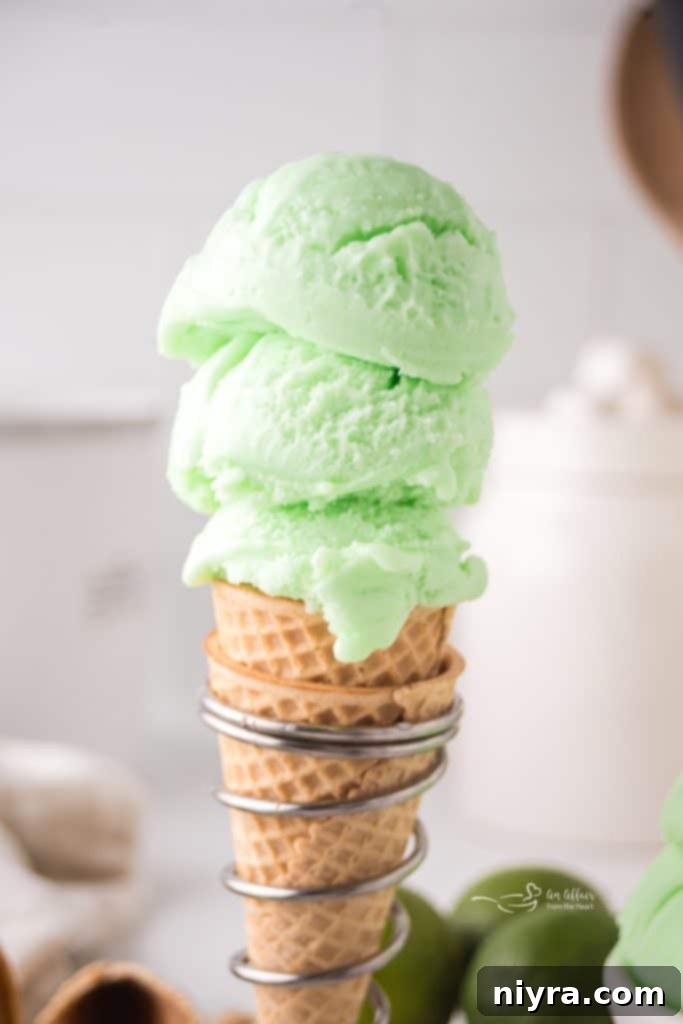 Three scoops of Copy Cat Baskin Robbins Daiquiri Ice in a double ice cream cone.