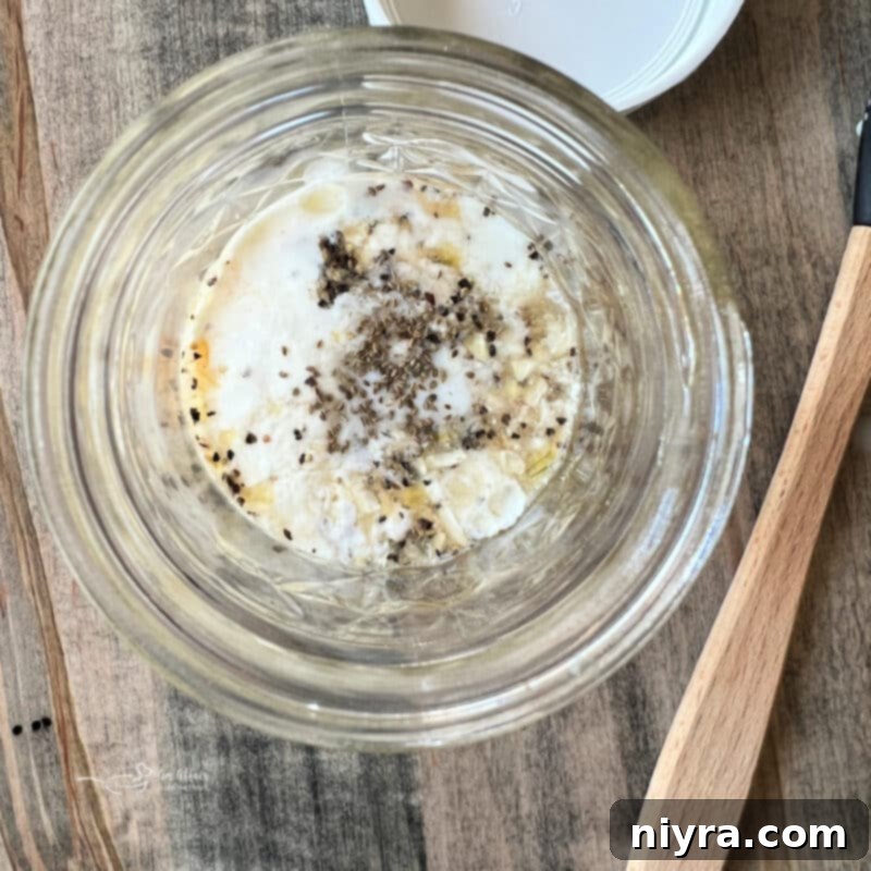 Woman adding dressing ingredients into a jar
