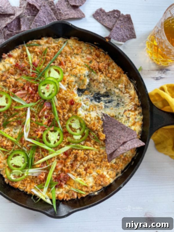 Baked Jalapeño Popper Dip 2 chip being dipped into jalapeño dip