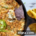 Baked Jalapeño Popper Dip 15 chip being dipped in jalapeño popper dip