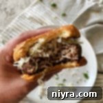 Swiss Cheese Krautburger in hand