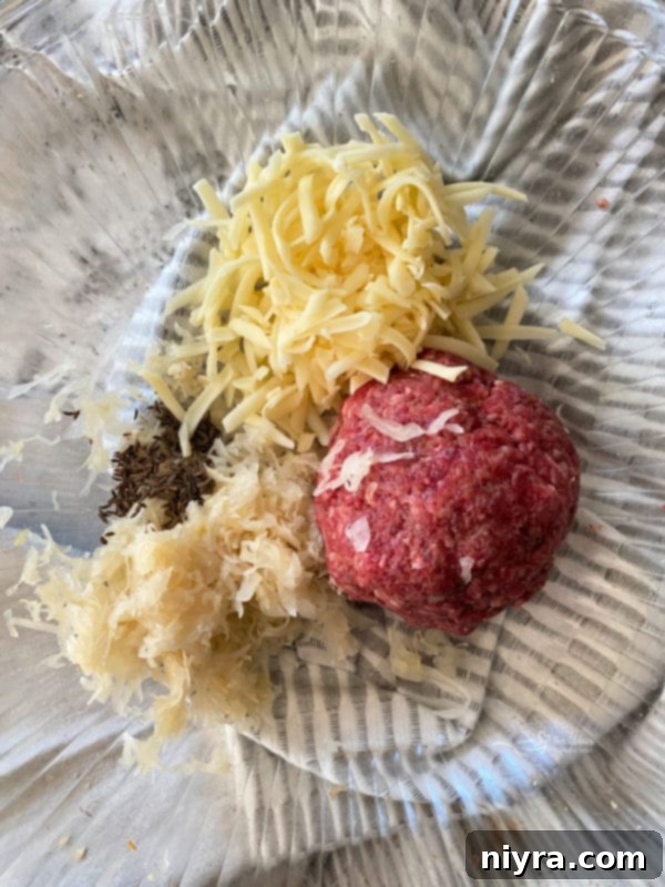 Kraut and Swiss cheese added to a portion of ground beef
