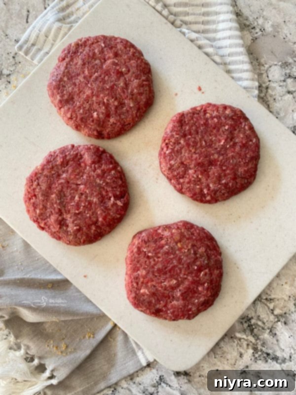 Four perfectly formed Swiss Cheese Krautburgers ready for grilling