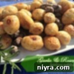 garlic & rosemary heirloom potatoes on a white serving platter