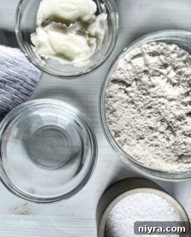 Homemade pie crust, partially baked and golden, in a glass pie dish.