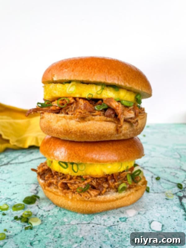 Close-up of Hawaiian BBQ chicken sandwich with pineapple and green onion